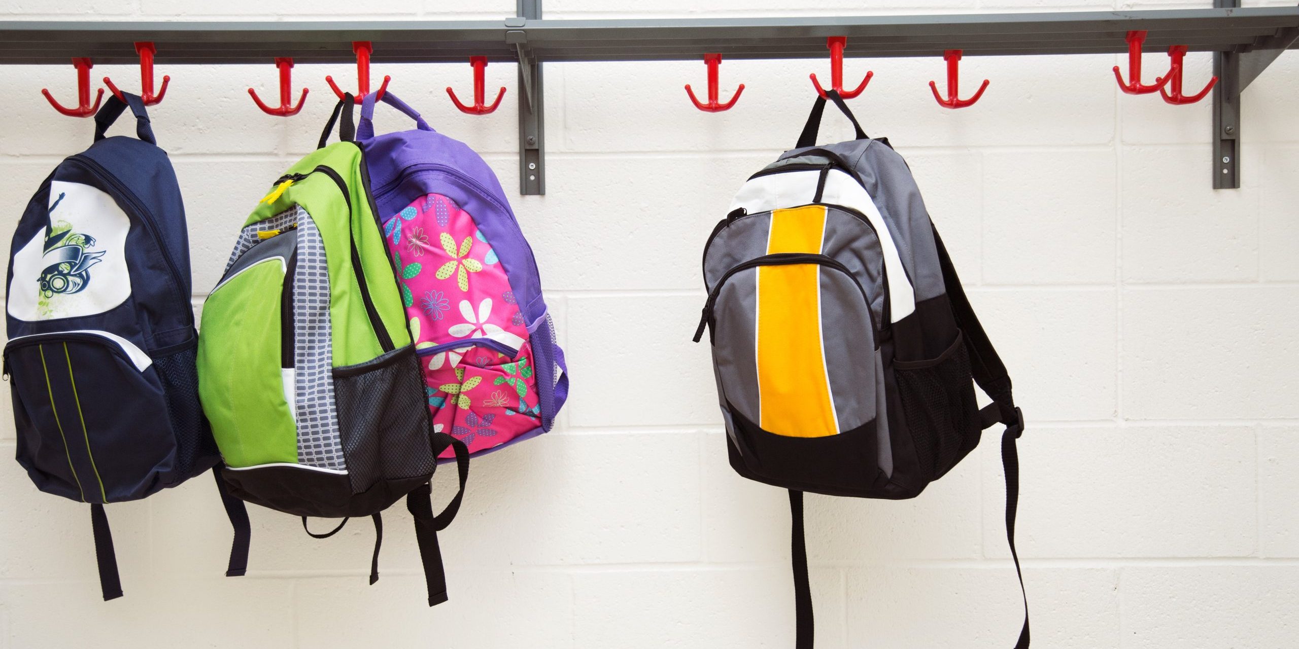 backpacks-hanging-on-hooks